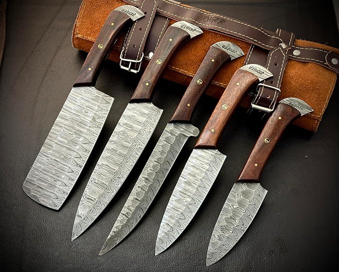 Damascus steel knife set with wood handles resting against a leather roll case