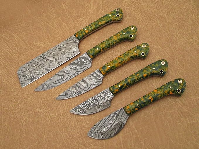 Close up of 5 piece Damascus steel knife set with mottled acrylic handles and nickel pins on tan leather