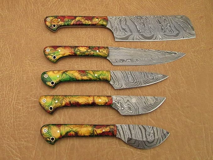 5 piece Damascus steel knife set with multicolor swirled acrylic handles fanned on tan leather background