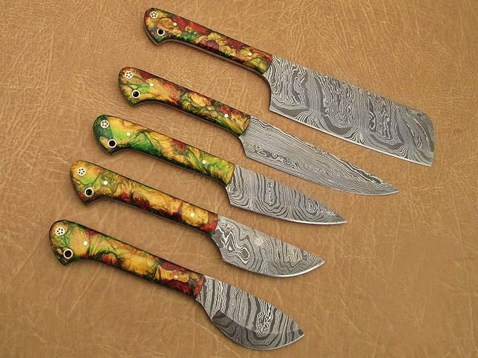5 piece Damascus steel knife set with swirled acrylic handles arranged closely on tan leather background