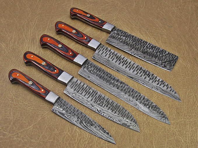 Pakka wood handle Damascus knives fanned out on leather background