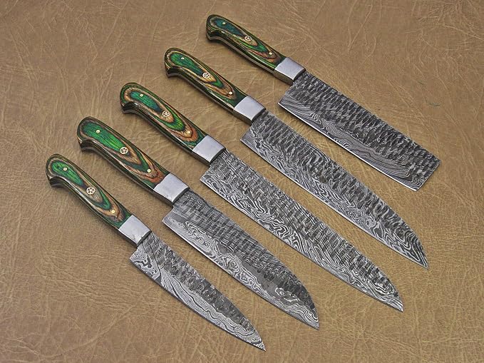 Close up of hammered Damascus steel blades with green pakka wood handles