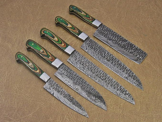 Close up of hammered Damascus steel blades with green pakka wood handles
