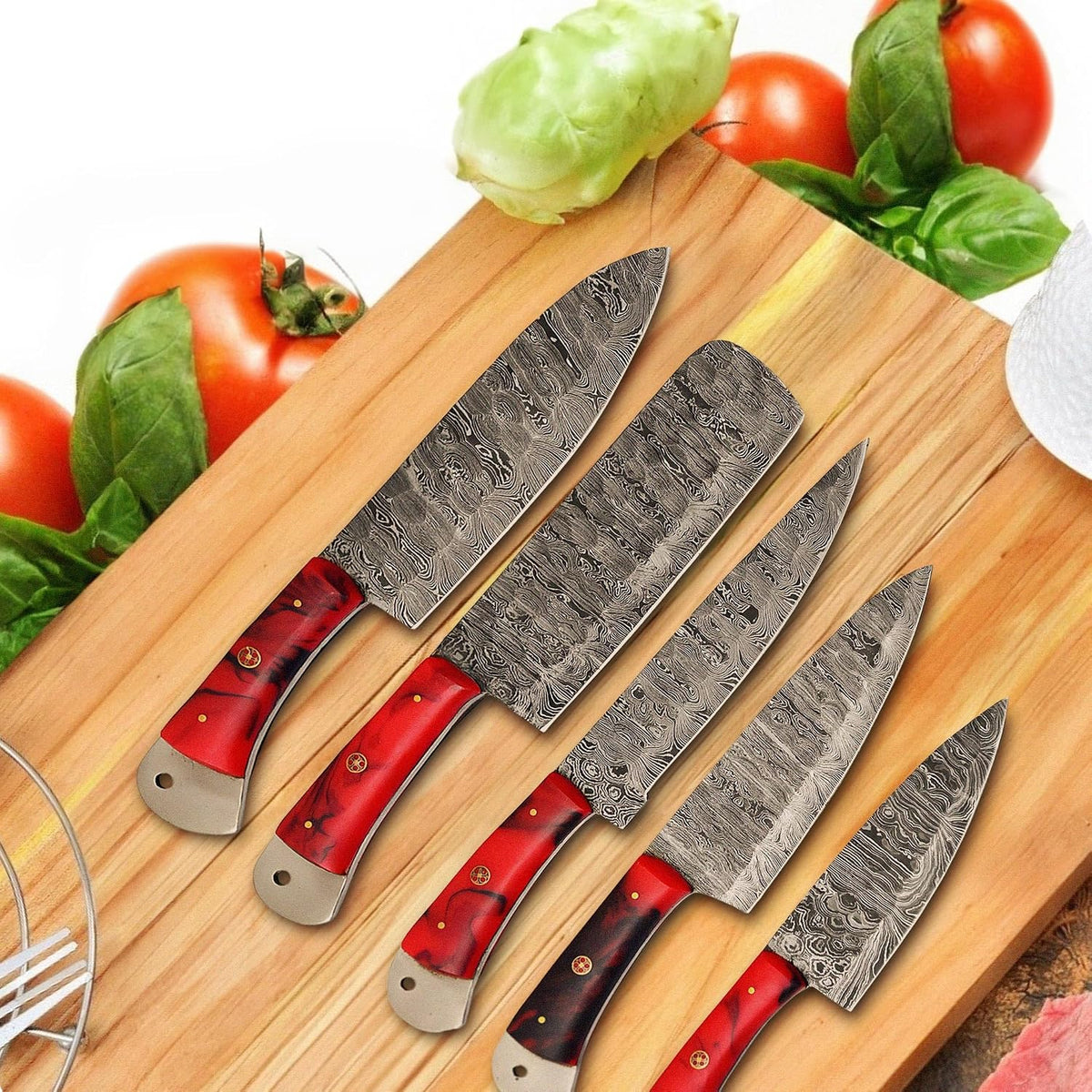 Damascus chef knives on a wood board with fresh vegetables