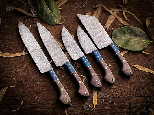 Damascus steel knife set with dark wood handles and teal spacers fanned outdoors