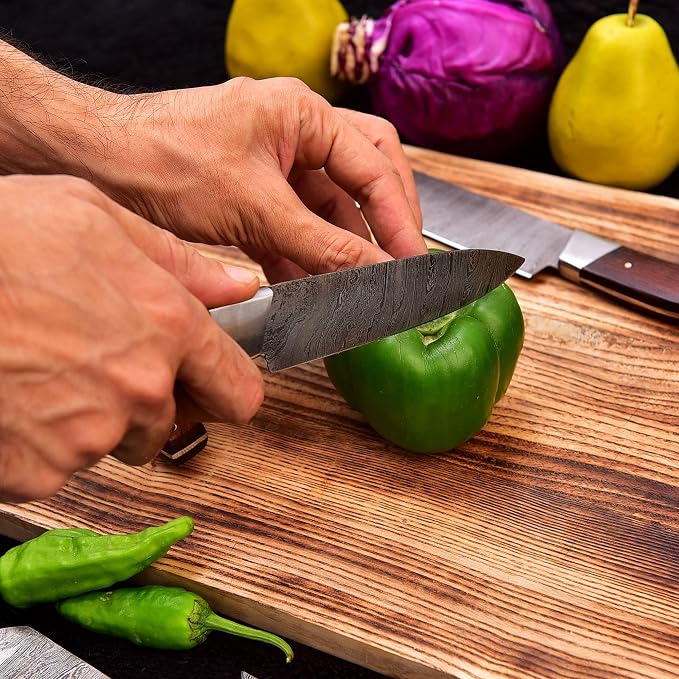 Damascus steel knife from the 5 Pieces Chef Knife Set slicing through a green bell pepper