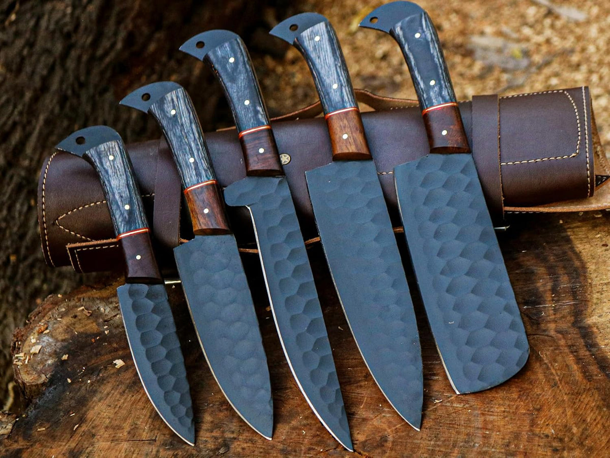 5 piece knife set with black blades arranged outdoors