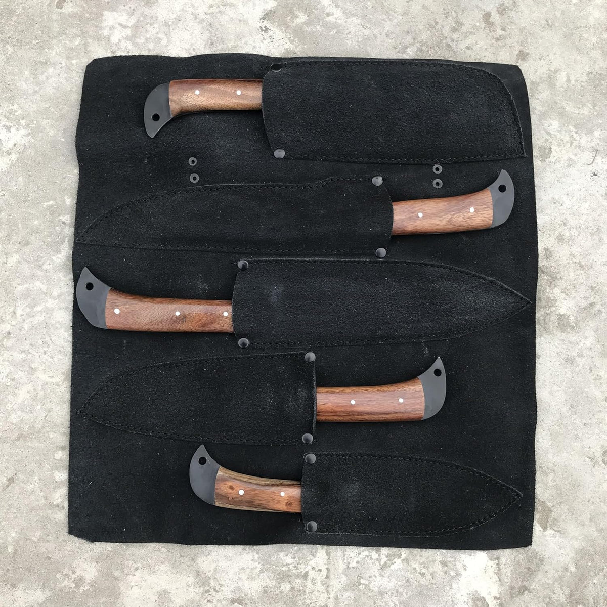 Leather knife roll with all five kitchen knives slotted into their own suede pockets