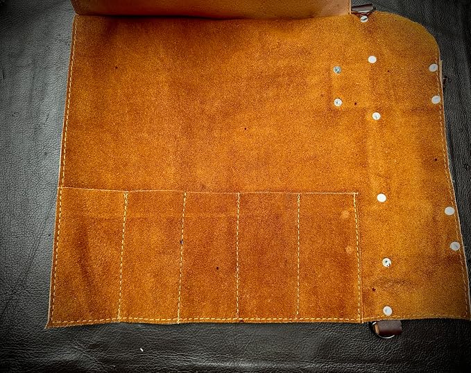 Empty leather roll case interior showing individual knife pockets