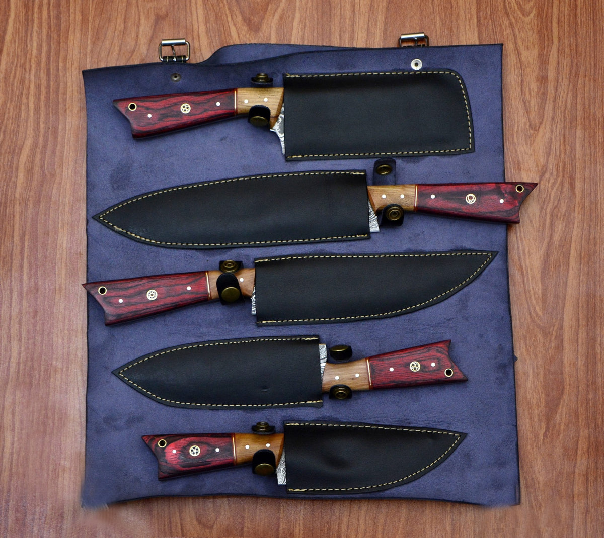 Damascus chef knife set fully sheathed in navy leather roll bag