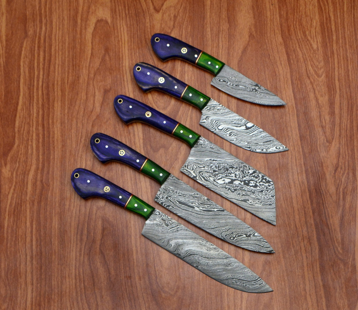 5 custom Damascus kitchen knives
with purple and green handles arranged neatly on a wooden background