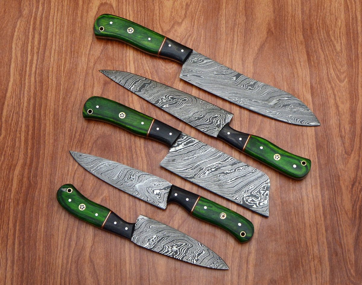 Damascus chef knife set with green pakka wood handles fanned on wood table