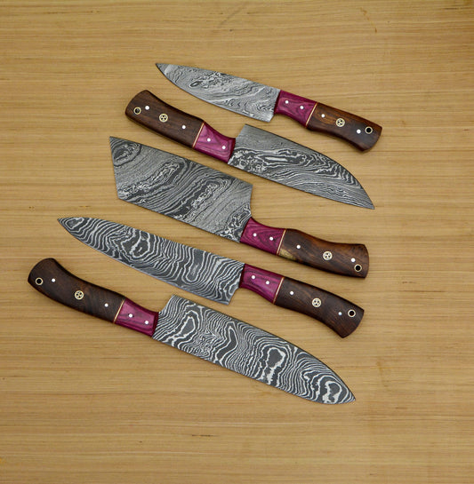 Five Damascus kitchen knives on wood.   