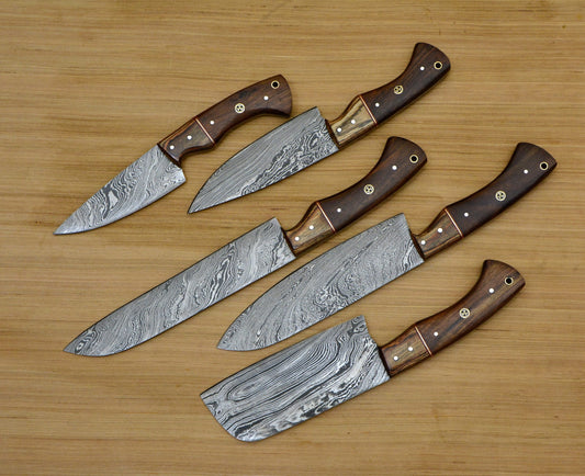 Five Damascus kitchen knives with two tone rosewood handles on a wood table