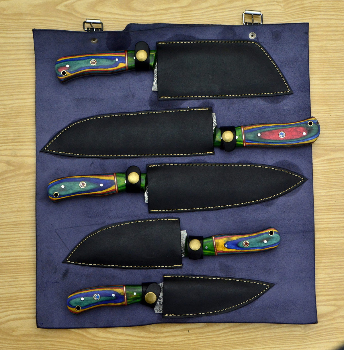 Damascus chef knife set fully sheathed in navy leather roll bag