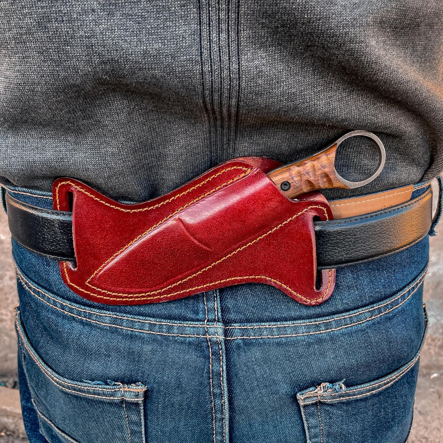 Best Bushcraft Knife carried in leather sheath on belt, worn at the back
