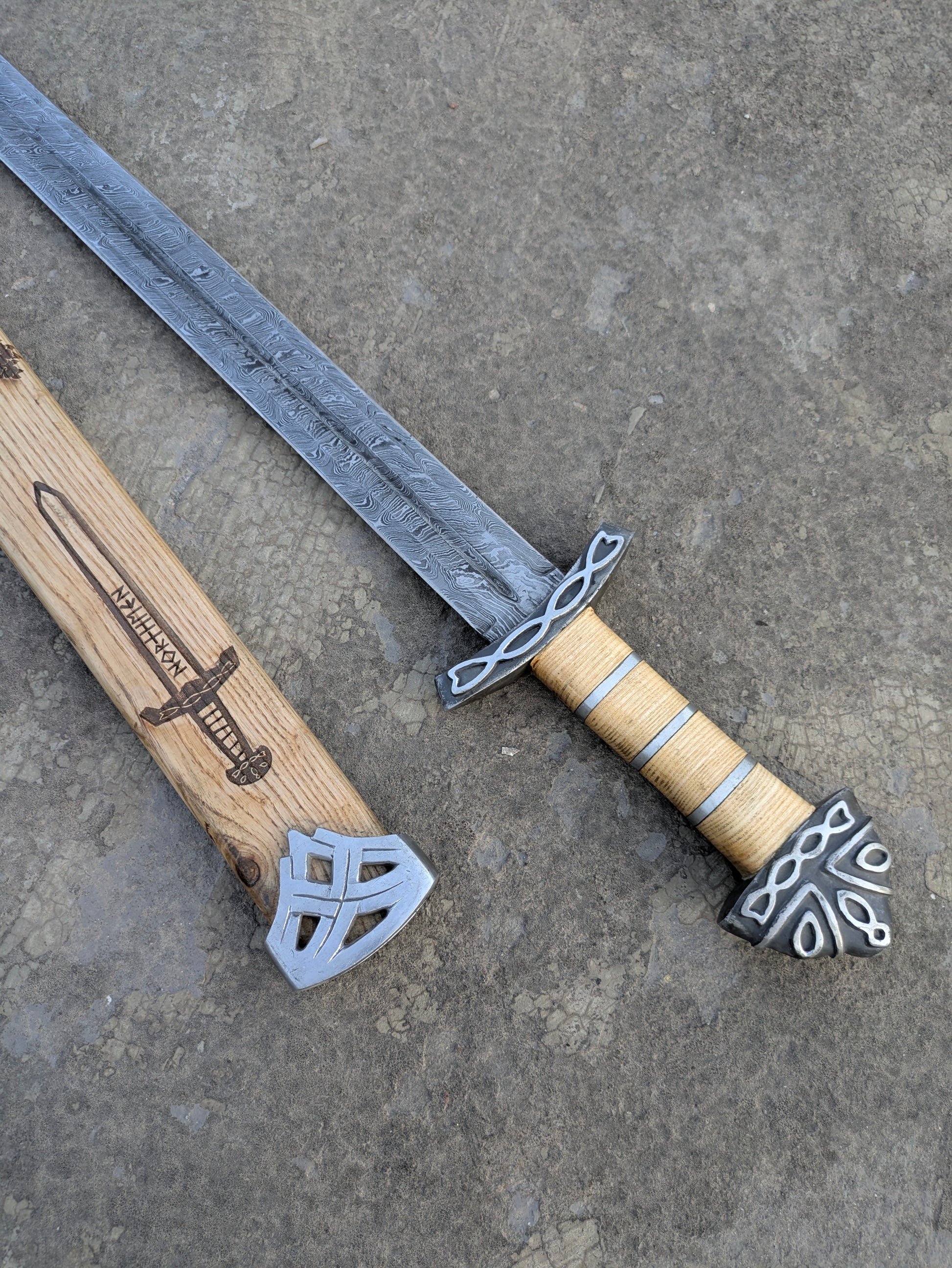 Damascus Steel Northman Viking Sword close-up showing Celtic knot pommel and crossguard