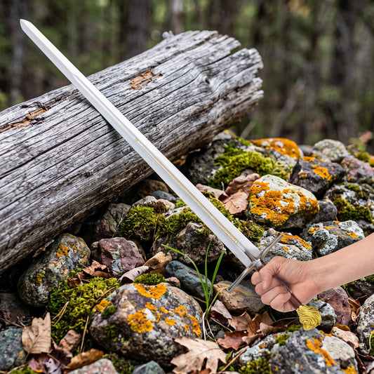 Hand holding decorative sword with lion head pommel outdoors