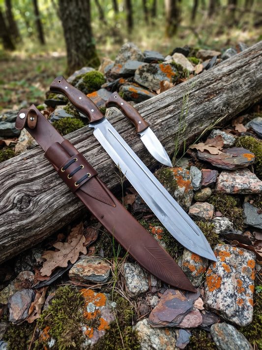 2 piece stainless steel knife set with Pakka Wood handles and leather style sheath on a woodland log