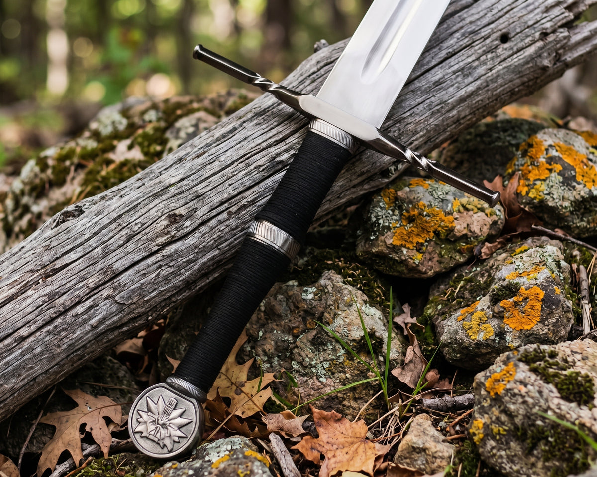 Close up of black cord wrapped grip, ribbed silver tone rings, twisted crossguard and wolf head medallion pommel