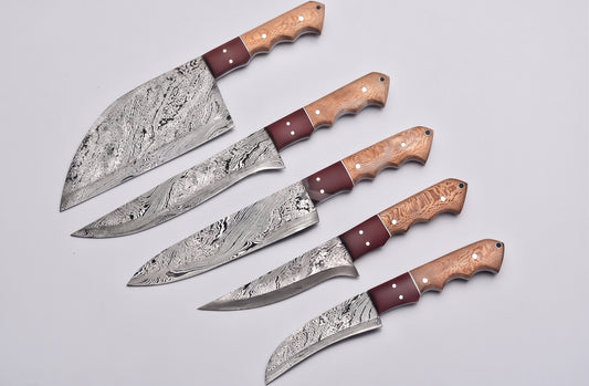 5 piece Damascus knife set fanned closely on white background