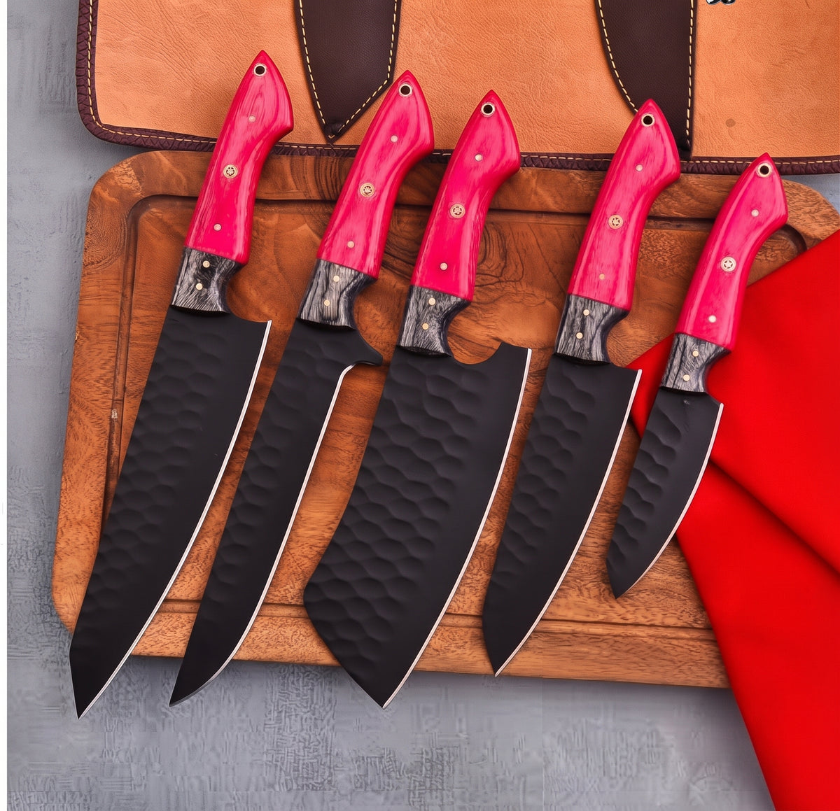 5 piece knife set with pink handles fanned on wood