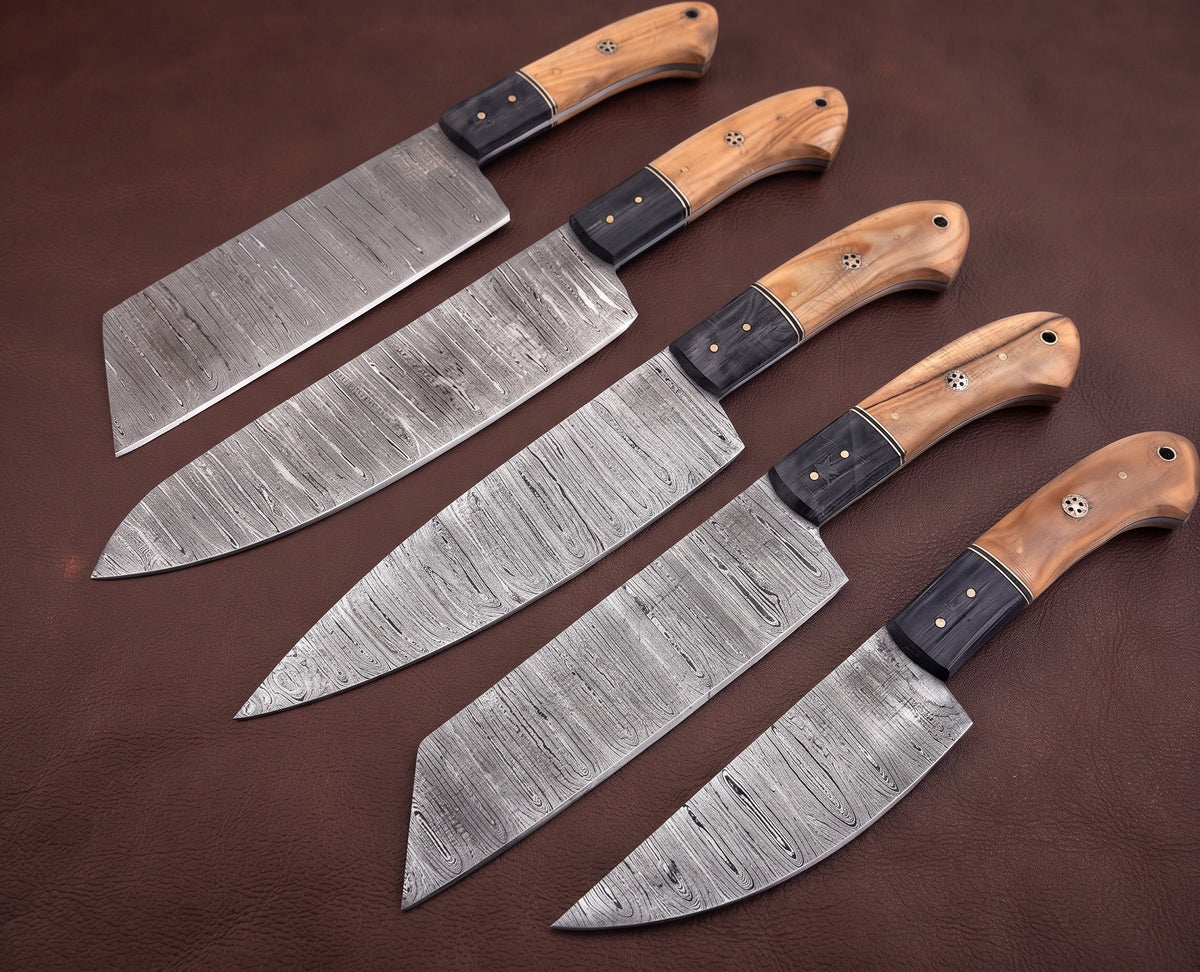Five Damascus steel knives with two tone wood handles arranged in an alternating row