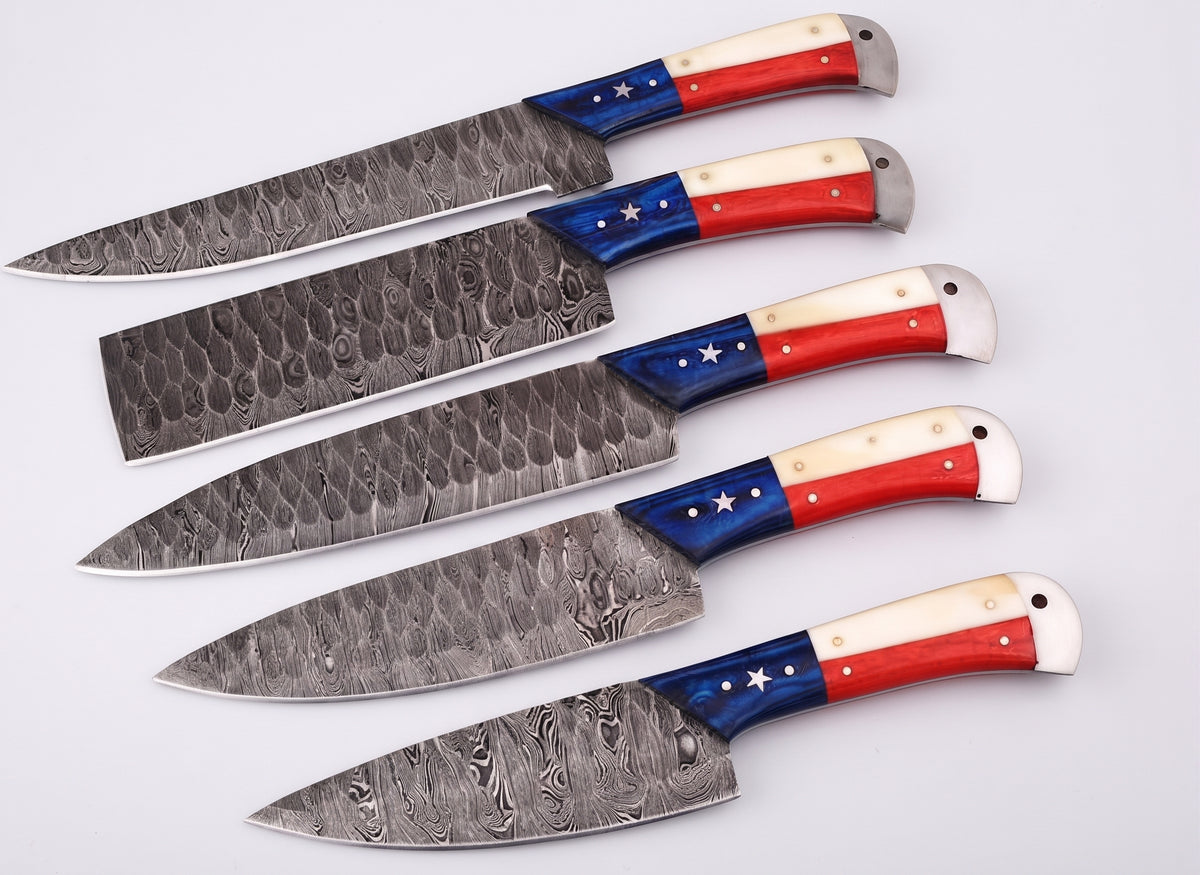 Close up angle of Damascus steel blades with red, white and blue star handles