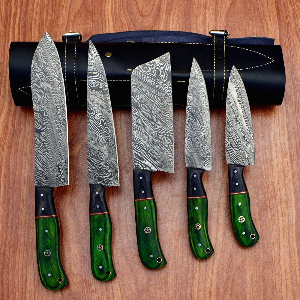 Green pakka wood handle knives with black bolster laid out on wood table