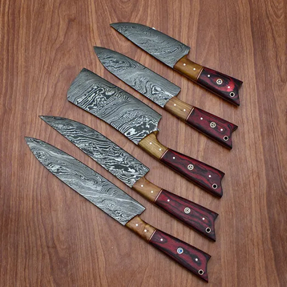 Red pakka wood handle knives with tan bolster fanned on wood table