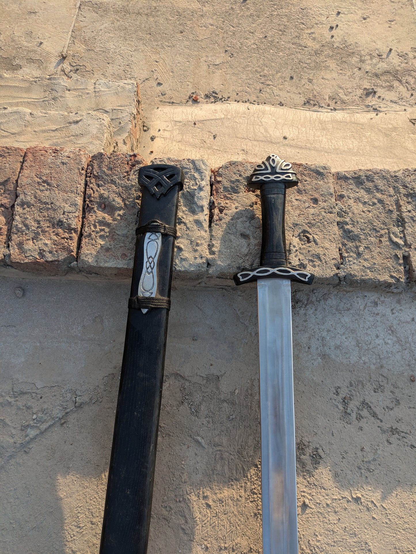 Handmade Fantasy Sword featuring Celtic knot fittings and black wooden scabbard