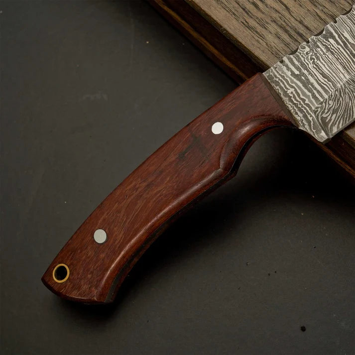 Wooden handle of skinner knife showing lanyard hole