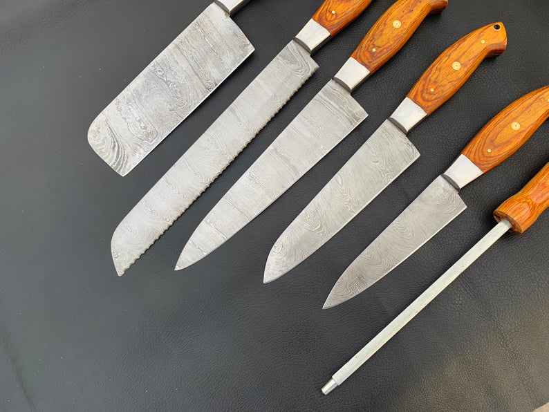 Orange pakka wood knife handles with brass pin detail close up
