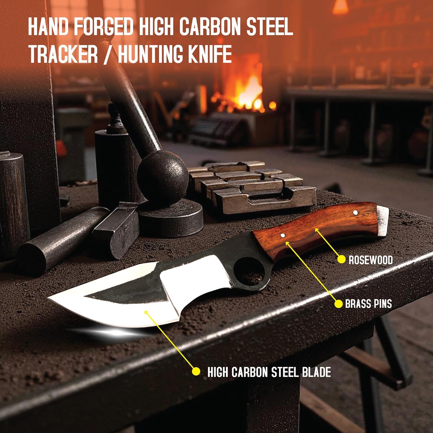 A hunting tracker knife resting horizontally on a dark, heavily textured metal workbench against a warmly lit, blurred blacksmith workshop background featuring a glowing forge and various metalworking tools. The knife has a polished wooden handle with a flat metal pommel and a distinct two-toned blade featuring a dark, textured upper section with a large circular finger hole, contrasting with the bright, polished silver cutting edges. Bold white text in the upper left corner reads 'HAND FORGED HIGH CARBON S