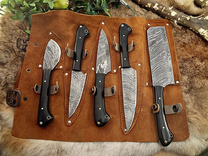 Leather knife roll showing five Damascus blades half drawn from their pockets
