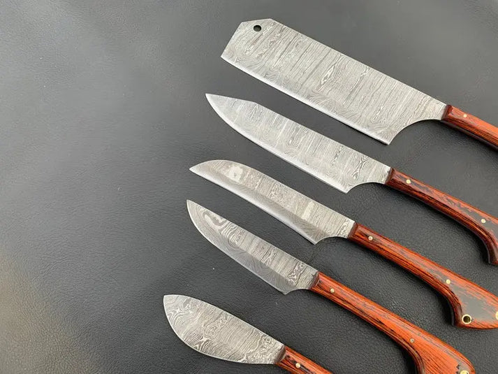Damascus blades close up, cleaver with a hanging hole down to a small paring knife